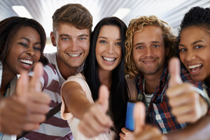 group of young adults giving a thumbs up sign